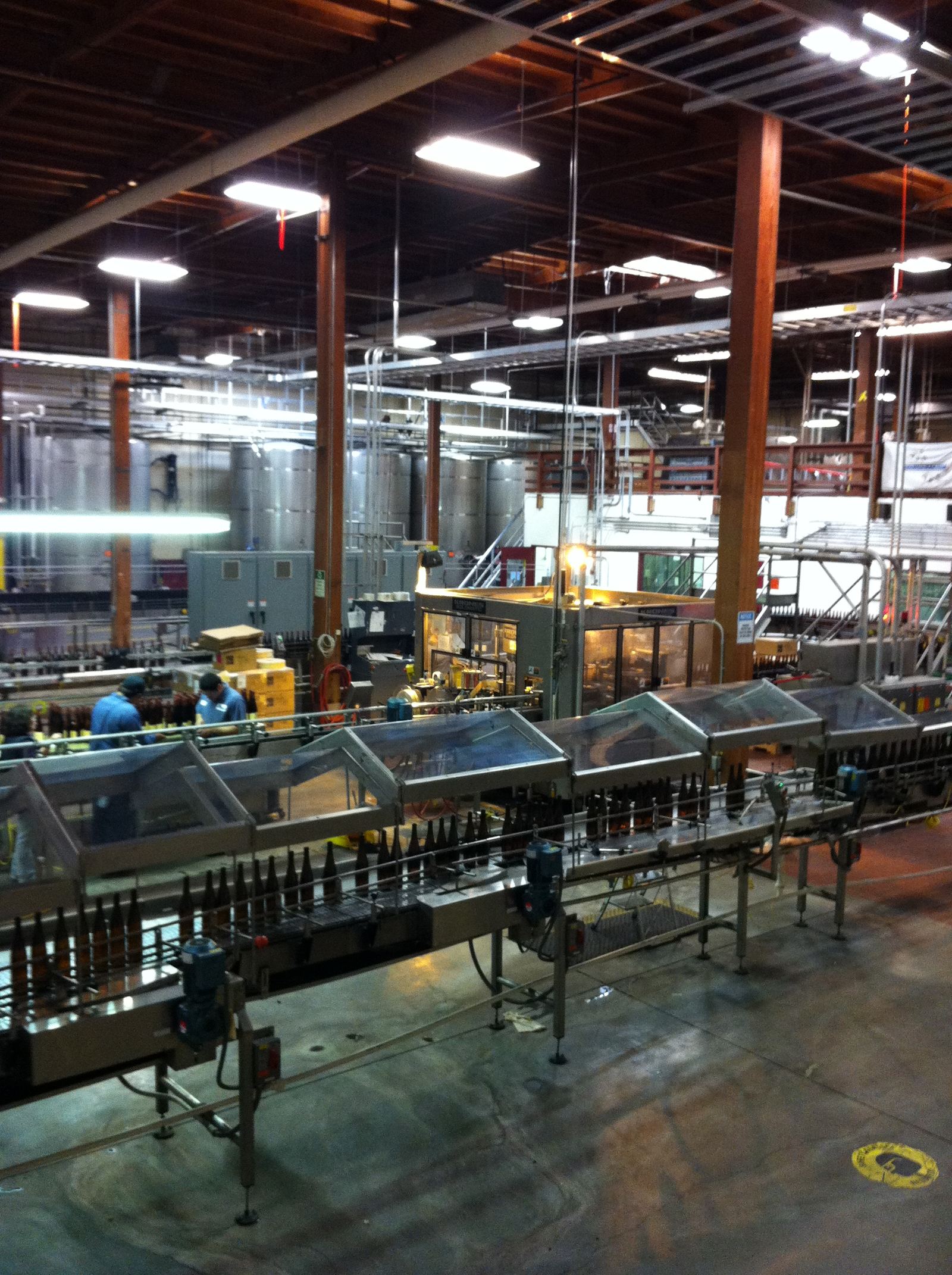 A bottling line filling glass bottles at a beverage plant
